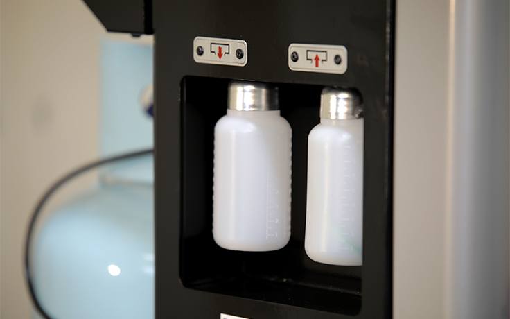New and Used Oil Bottles on AC Recovery Machine